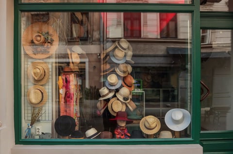 Display window of a hat shop with a variety of straw hats